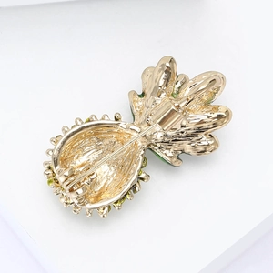 Back view of gold pineapple brooch with secure pin clasp and vibrant enamel edges