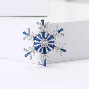 Elegant silver snowflake brooch with blue rectangle stones and white cubic zirconia