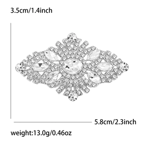 Elegant rhinestone brooch with large central oval stone and symmetrical silver frame
