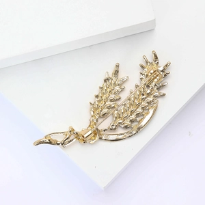 Detailed back view of gold wheat ear brooch showing pin clasp and metallic texture