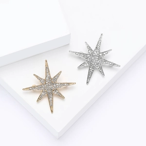 Elegant eight-pointed star brooches with rhinestones in gold and silver finish