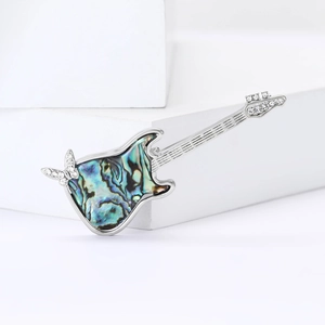 Elegant silver guitar brooch with colorful abalone shell inlay and sparkling rhinestones