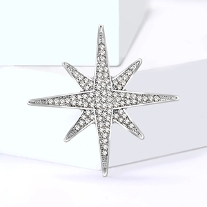 Elegant silver eight-pointed star brooch featuring shimmering rhinestones and a polished finish