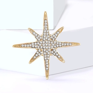 Exquisite gold eight-pointed star brooch set with brilliant zircons on a white platform