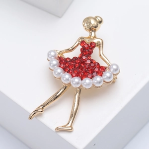 Dettaglio della spilla ballerina in lega dorata con cristalli rossi e perle lucide