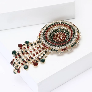 Vintage gold alloy brooch with colorful crystals and rhinestones in a circular tassel design