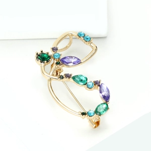 Détail macro de broche stéthoscope en alliage avec strass colorés et plaqué or