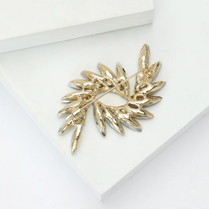 Detailed back view of colorful rhinestone swirl brooch showing pin clasp and metal texture