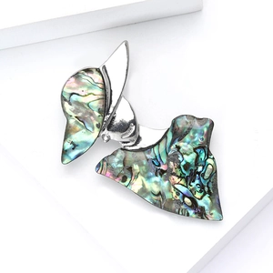 Artistic abstract lady brooch in silver alloy with iridescent shell inlay on white stand
