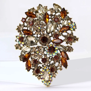 Macro shot of antique gold floral brooch featuring amber crystals and marquise stones
