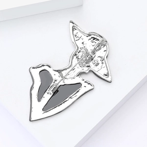 Macro view of the silver-plated alloy brooch back showing detailed safety pin clasp