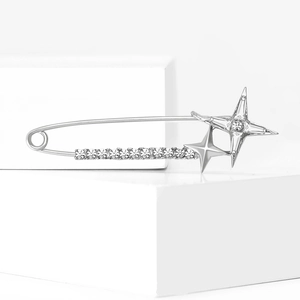 Silver star safety pin brooch with sparkling crystals on a minimalist pedestal