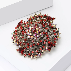 Macro d'une broche vintage avec cristaux rouges sur une base florale en alliage de bronze
