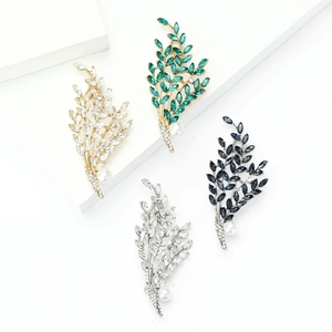 Elegant leaf branch brooches with colorful rhinestones and faux pearls on display