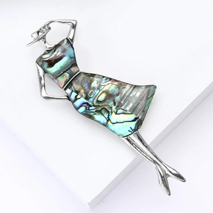 Elegant vintage lady brooch in silver alloy with iridescent shell inlay on white stand