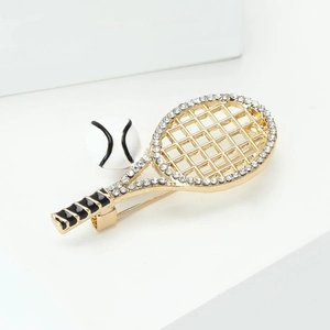 Detail of gold alloy tennis racket brooch with pavé rhinestones and black enamel handle