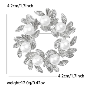 Detail view of silver leaf wreath brooch with white pearls, size 4.2cm x 4.2cm