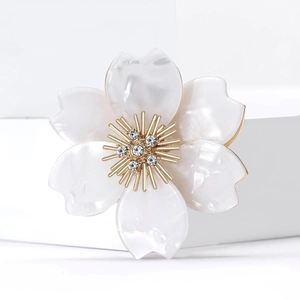 Elegant acrylic cherry blossom brooch with white pearlescent petals and golden crystals