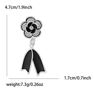 Detail view of rhinestone camellia flower brooch with measurements 4.7cm by 1.7cm