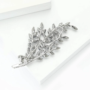 Detailed back view of silver alloy branch brooch showing pin clasp and casting texture