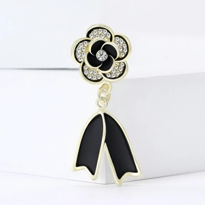 Luxury camellia flower brooch with gold plating, black enamel, and sparkling rhinestones