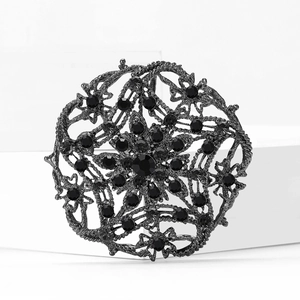 Vintage hollow alloy brooch with black rhinestones and symmetrical floral design in gunmetal