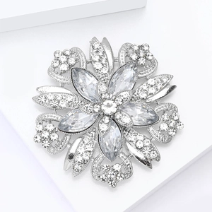 Elegant silver flower brooch with marquise crystals and sparkling rhinestones on white
