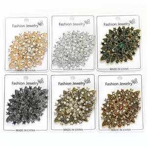 Detailed comparison of six rhinestone flower brooches in gold, silver, and bronze finishes