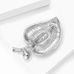 Detailed view of silver leaf brooch with pearl accent and secure pin clasp on back