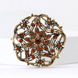 Retro hollow geometric brooch with warm-toned amber rhinestones on gold metal base
