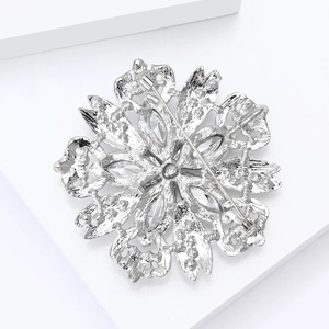 Detailed back view of a silver floral brooch showing its secure pin buckle structure