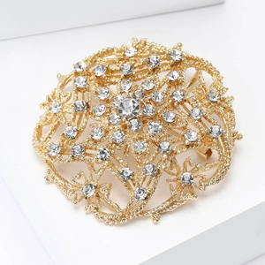 Close-up of a vintage hollow-out sunflower brooch with sparkling crystals and gold finish