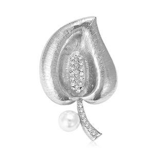 Elegant silver leaf brooch with sparkling rhinestones and white pearl on white background