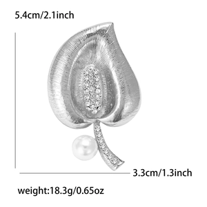 Elegant silver leaf brooch with sparkling crystals and a dangling white pearl