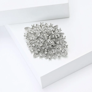 Detailed macro shot of vintage silver snowflake brooch with sparkling rhinestones
