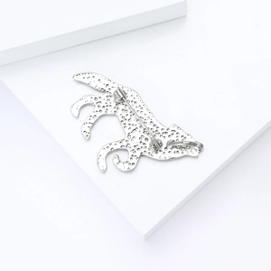 Detailed back view of silver cheetah brooch showing metal texture and safety pin clasp