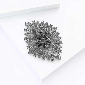 Detailed back view of a luxury rhinestone bridal brooch with a secure safety pin fastener