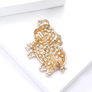 Detailed back view of golden pig brooch showing secure pin fastener and metallic texture