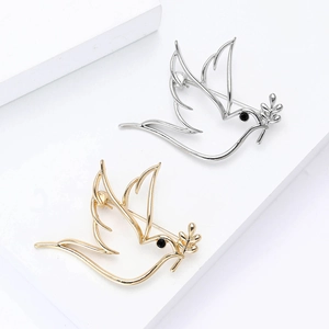 Broche colombe évidée minimaliste en finition or et argent avec détail d'olivier