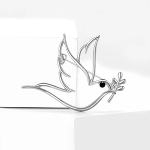 Broche colombe minimaliste en argent avec branche d'olivier et œil en pierre noire