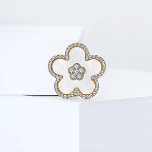 Elegant five-petal flower brooch with gold frame, white enamel and sparkling crystals