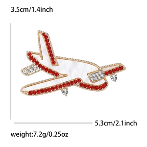 Elegant gold airplane brooch with white shell finish and red rhinestones, 5.3x3.5cm