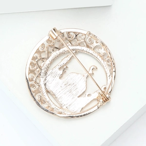 Detailed back view of round gold alloy Taj Mahal brooch showing secure metal pin clasp