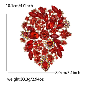Detailed size view of a large vintage red crystal brooch with golden alloy setting