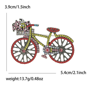 Detailed view of rhinestone bicycle brooch with dimensions 3.9cm by 5.4cm and 13.7g weight