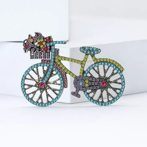 Vintage alloy bicycle brooch with colorful rhinestones and floral basket detail