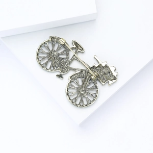 Macro shot of the sturdy safety pin clasp on vintage alloy bicycle brooch back