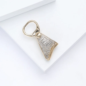 Detailed view of rhinestone-studded soda tab brooch with polished gold plating