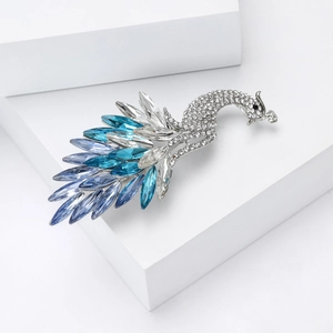 Detailed view of elegant peacock brooch with blue rhinestones and silver plating
