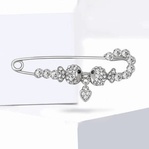 Silver fish safety pin brooch with sparkling rhinestones and a heart-shaped pendant